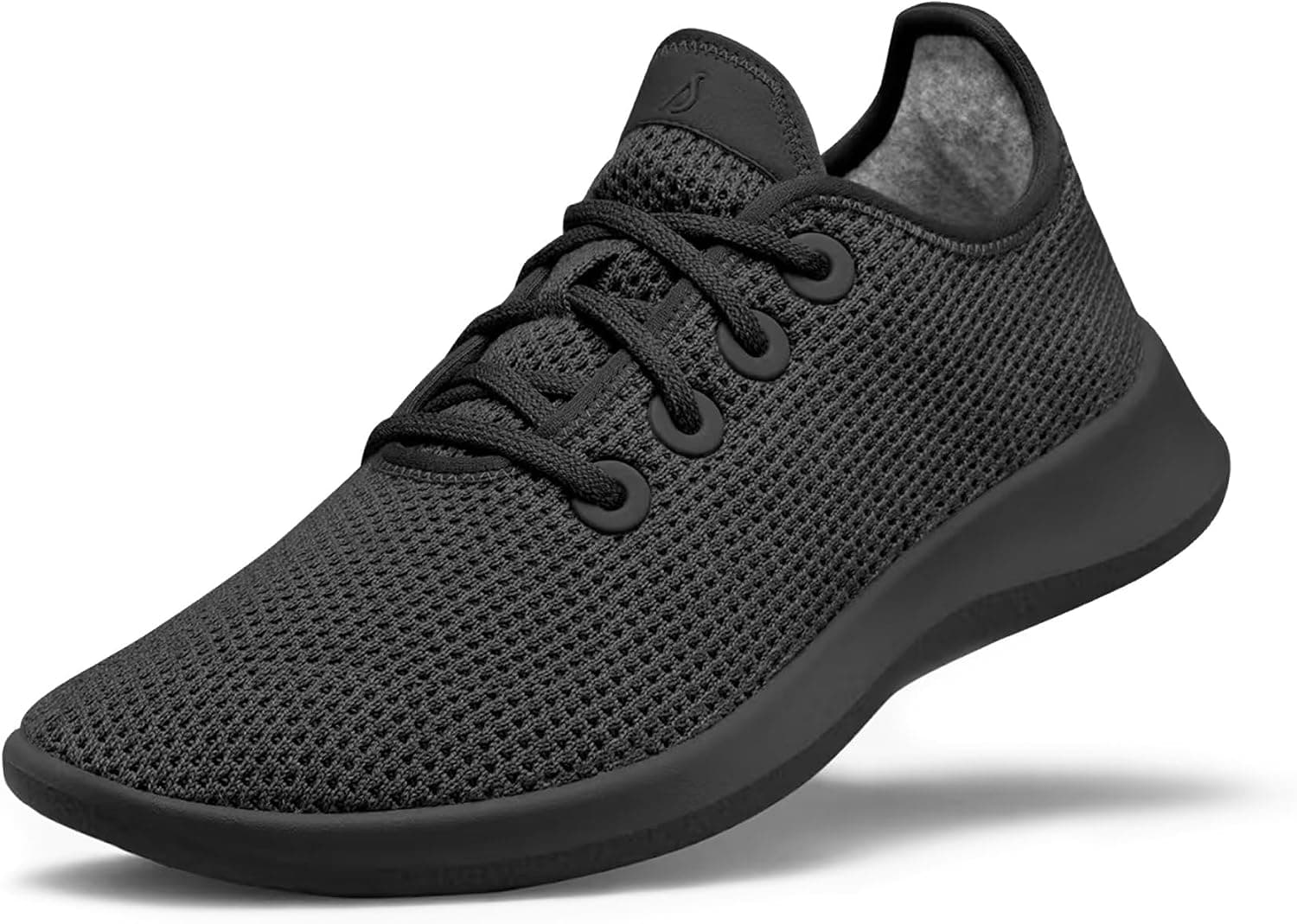 Black Allbirds Tree Runner sneaker with a black sole, side view on white