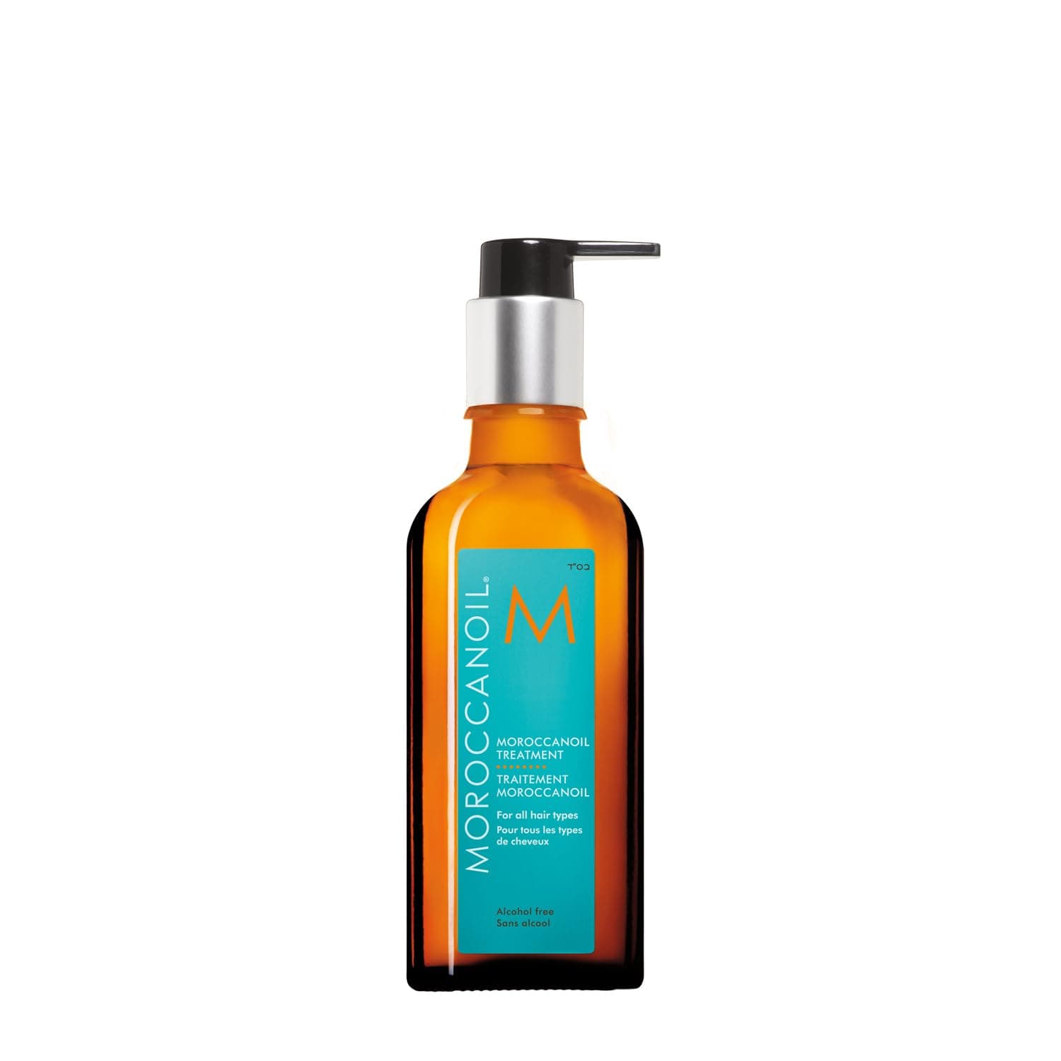 Moroccanoil Treatment bottle, amber glass with a purple label, standing on white